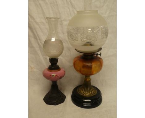 A Victorian brass oil lamp with opaque glass reservoir and etched shade and one other metal and ceramic oil lamp (2)
