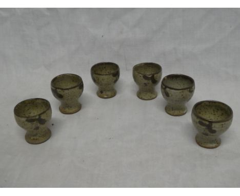 A set of six 1960s Leach pottery tapered egg cups with speckled decoration 