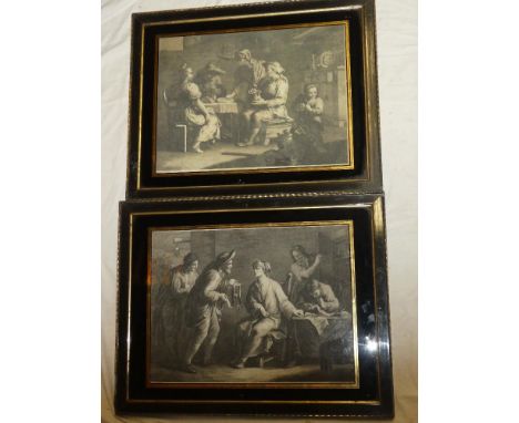 A pair of 18th Century black and white classical engravings depicting interior scenes with figures in black and gilt decorate