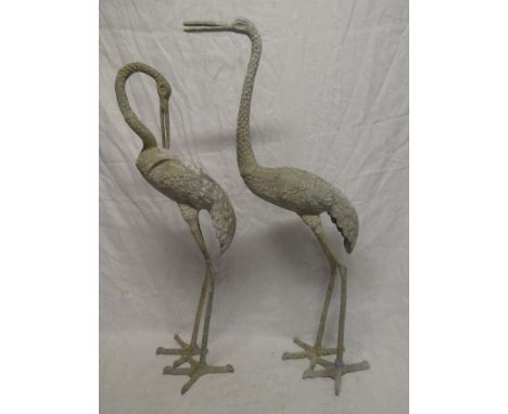 A pair of aluminium figures of storks, 34" and 31" high