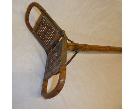 An old brass mounted bamboo folding shooting stick with cane work seat