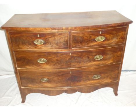 A Victorian mahogany bow-front chest of two short and two long drawers with brass ring handles on bracket feet