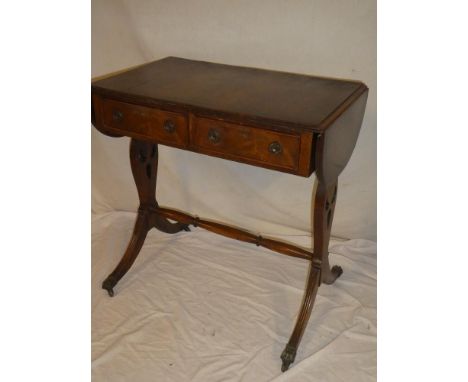 A polished mahogany rectangular drop leaf sofa table with two drawers in the frieze on tapered supports and scroll legs