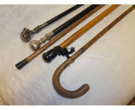 Five various walking sticks including horn mounted cane, two modern canes with silver plated tops, silver mounted walking sti