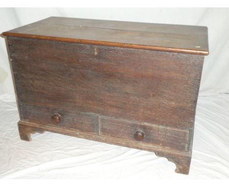 An early 19th Century oak rectangular mule trunk with compartment enclosed by a hinged lid above two base drawers on bracket 