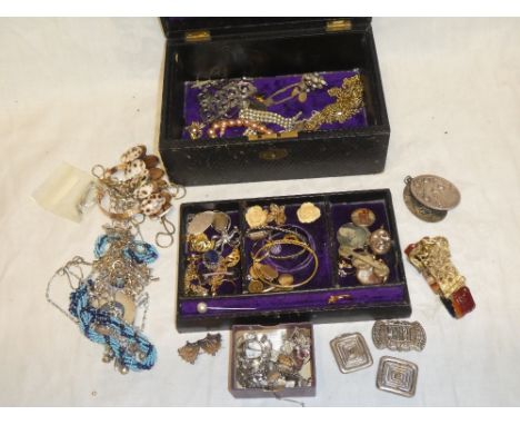 A Morocco leather jewellery box containing a selection of various dress jewellery including decorative bangle, necklaces, ear