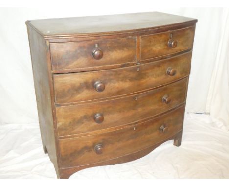 A 19th Century mahogany bow-front chest of two short and three long drawers with turned handles on bracket feet (af)