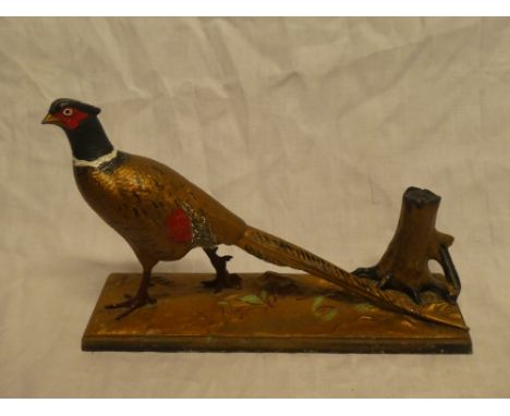 A large painted spelter table lighter in the form of a cock pheasant on rectangular base