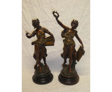 A pair of bronzed spelter figures of classical females after Moreau on circular wooden bases, 20" high overall