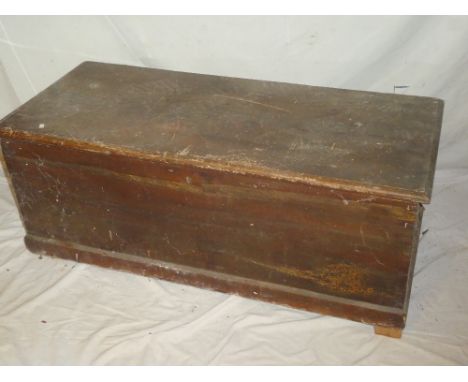 A 19th Century stained pine rectangular trunk with hinged lid, 43" long