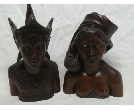 Two Eastern carved teak bust figures of a male and female, 12" high