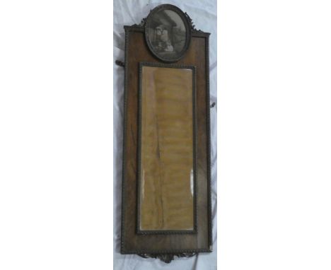 An old bevelled rectangular wall mirror in carved oak frame surmounted by an oval panel containing a landscape print with fig