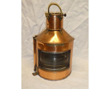 An old brass mounted copper ship's bow port lantern "Patt. 23" with internal burner