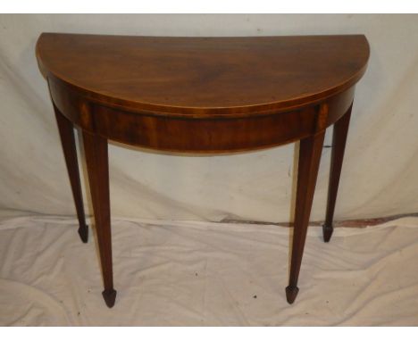 A 19th Century inlaid mahogany semi-circular turnover top card table with baize lined playing surface on square tapered legs 