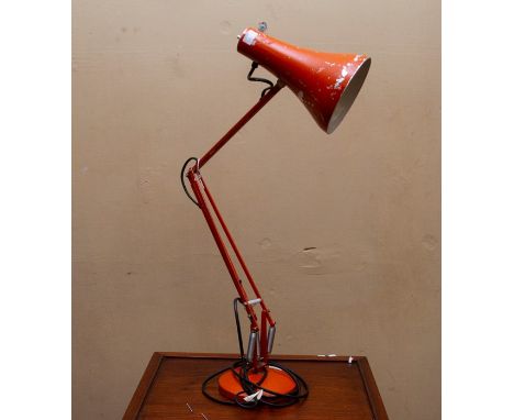 A mid 20thC Anglepoise lamp. Orange painted metal on heavy base. Extends to approx 1 metre.