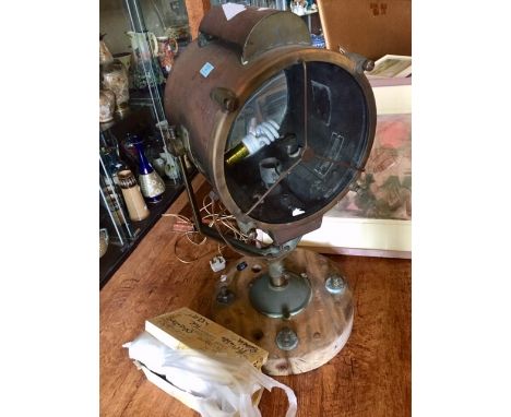 Vintage searchlight on wooden base.