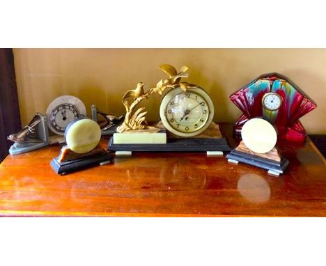 3 clocks. Art Deco clock with garnitures in celadon green on a black bases. Garnitures are matching spheres and clock has gil