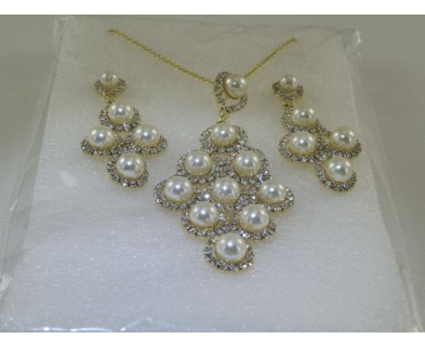 White Faux Pearl and Crystal Pendant Necklace and Earrings Set, the three pendant pieces comprising openwork designs of white
