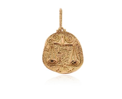A gold medallion zodiac pendant, the asymmetrical oval medallion depicting the Scales of Justice and reading 'Libra' in textu