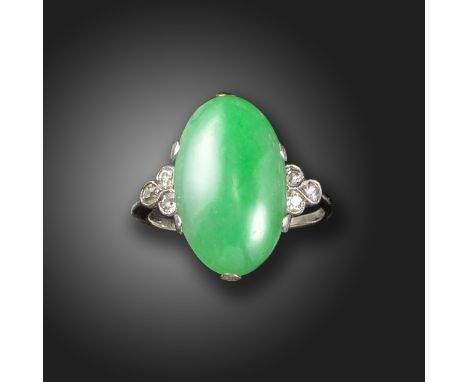 A jade and diamond ring, the green jadeite jade cabochon set with a trefoil of old circular-cut diamonds in white gold, size 