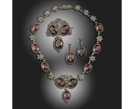 A late 18th century cut-steel and paste parure, comprising a necklace, brooch and earrings, each set with oval red glass cabo