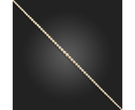 A single-row natural pearl necklace, the natural pearls graduate from 2.1 - 6.6mm, with a diamond-set clasp, 44cm long Accomp