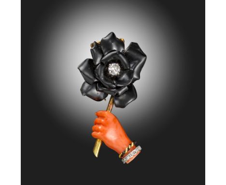 A coral, diamond and enamel 'Mascot' brooch by Cartier, c.1940, designed as a hand holding a flower, the carved coral hand se
