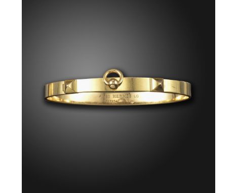 A 'Collier de Chien' gold bangle by Hermes, designed as a dog collar in gold, signed Hermes, numbered 117274, French control 