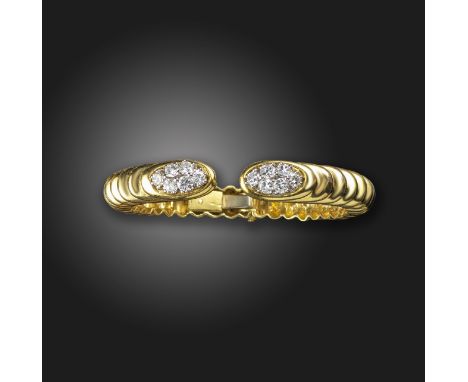 A diamond set gold bangle believed to be by Wander, the terminals set with clusters of gradauted round brilliant-cut diamonds