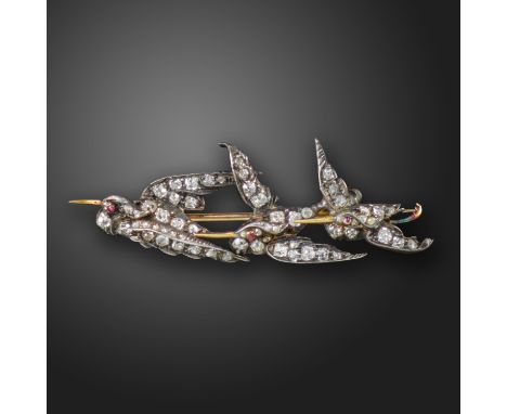 A late Victorian diamond-set bird bar brooch, the three flying storks set with cushion-shaped diamonds and ruby eyes in silve