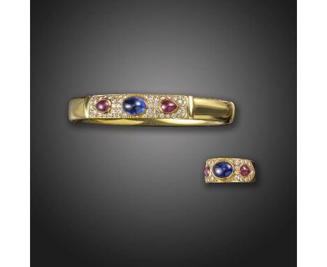 A sapphire, ruby and diamond-set gold bangle, set with cabochon sapphires, rubies and pave-set with round brilliant-cut diamo