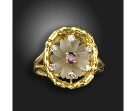 A gem-set flowerhead ring by John Donald, the rock crystal flower set with a ruby centre within an abstract 18ct yellow gold 