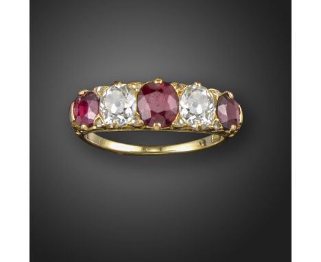 A late 19th century ruby and diamond half-hoop ring, set with graduated cushion-cut rubies and cushion-cut diamonds, in a scr