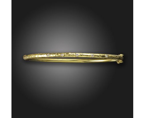 A diamond-set textured gold bangle, set with five round brilliant-cut diamonds in hammered gold, 6cm internal diameter, 11.3g
