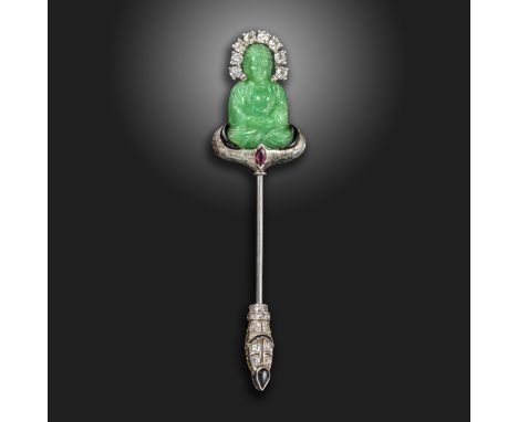 An Art Deco gem-set white gold stick pin by Ghiso, the seated green glass Buddha set with old circular-cut diamonds around th