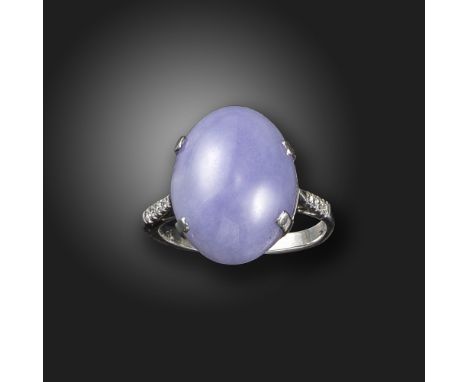 A lavender jade and diamond ring, the jadeite cabochon is set with diamond shoulders in white gold, size M 1/2 Accompanied by