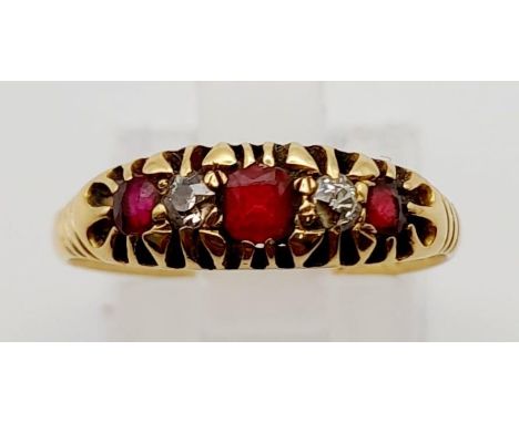 A Vintage 18K Yellow Gold Ruby and Diamond Ring. Three rubies and two diamonds. Size N. 2.17g. 