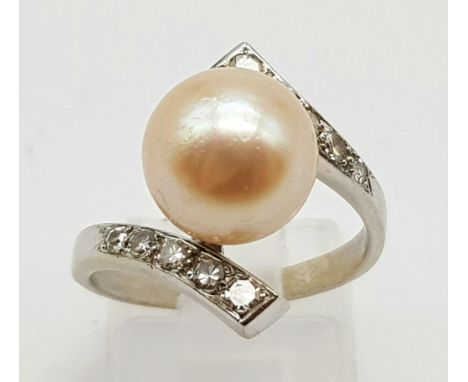 An 18K White Gold Diamond and Natural Pearl Ring. Size N. 5.2g. 