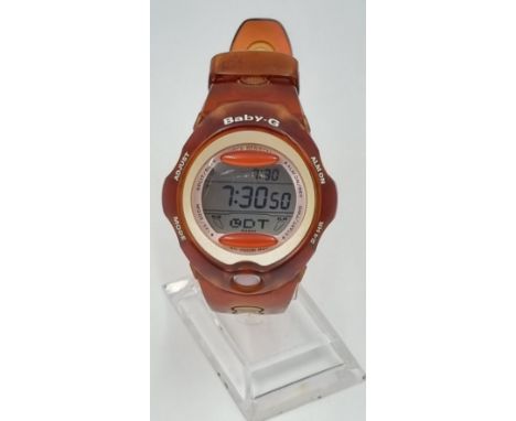 A Casio Baby-G Shock-Resistant Watch. Brown and yellow rubber strap and case. Good Condition in working order. 