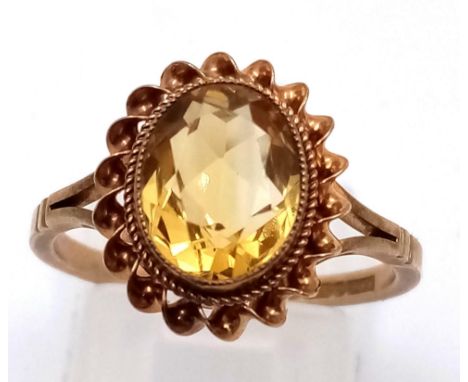 A 9 K yellow gold ring with a beautiful oval cut citrine. ring size: N, weight: 2.65 g. 