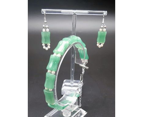 A good quality, pale green jade and genuine seed pearls bracelet in the shape of bamboo with matching earrings.Bracelet lengt