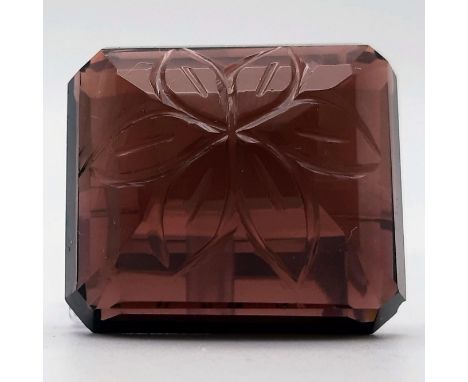 A large (110 carats), emerald cut and hand engraved, flawless, natural amethyst from Brazil. Dimensions: 32 x 28 x15 mm. With