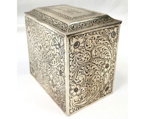 AN ANTIQUE SILVER TEA CADDY DATED 1909  WITH HAND CHASED FLORAL DESIGN ON ALL SIDES , HINGES  AND LID WORKING PERFECTLY.  10.