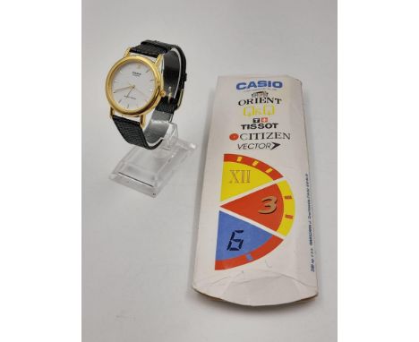 A CASIO QUARTZ WATCH WITH WHITE FACE AND LEATHER STRAP. 