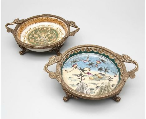 A pair of Victorian style Wong Lee brass and ceramic plates. Brass mounts with a scrolling, foliate design. Plates are hand p