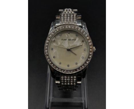 A LADIES DIAMONTE DRESS WATCH BY RIVER ISLAND WITH MOTHER OF PEARL FACE 