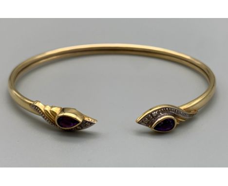 A 9K Yellow Gold Bangle with Amethyst Stones and four small diamonds. 6cm inner diameter. 6.75g 