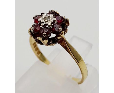 An 18K Yellow Gold Diamond and Ruby Floral Cluster Ring. Size L. 2.8g 