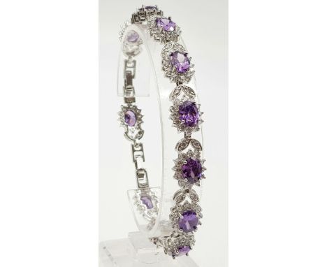 A Purple Amethyst and White Topaz 925 Silver Tennis Bracelet. 18cm. 