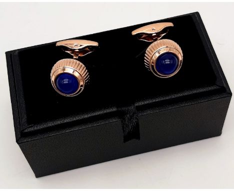 A pair of 18 K rose gold plated CARTIER cufflinks with watch crown motif and adorned with blue synthetic spinel,offering endl
